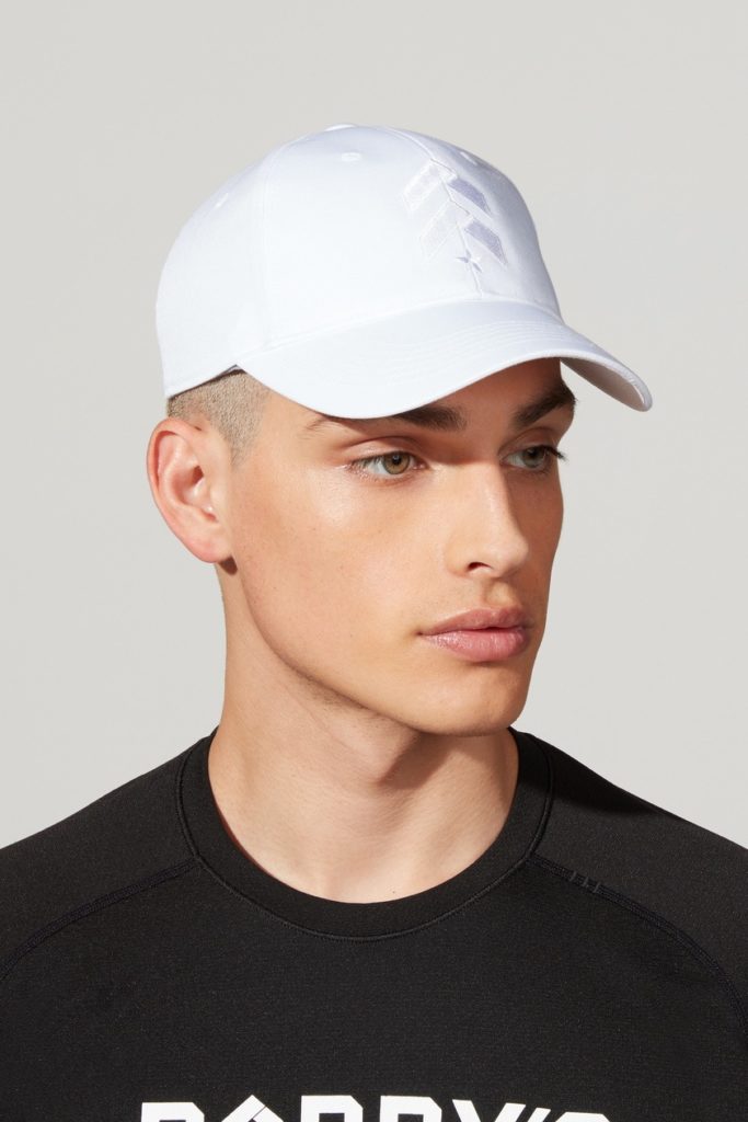 A male model wearing white cap and black t-shirt