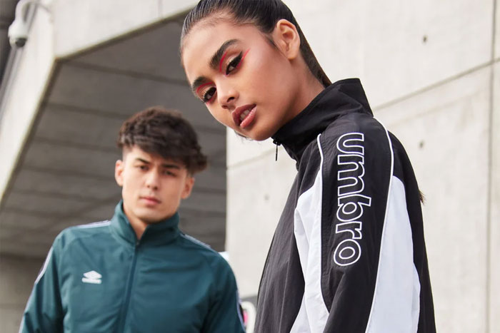 A teenage girl and a boy models with Umbro jerseys