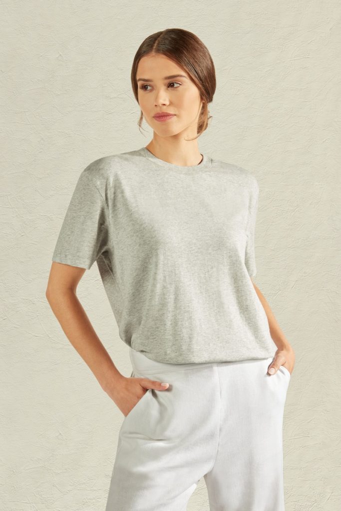 A female model with white trousers and light grey tshirt