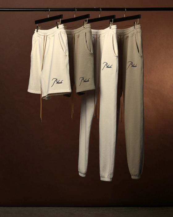 Rhude Shorts and tracks hanged on hanger rod