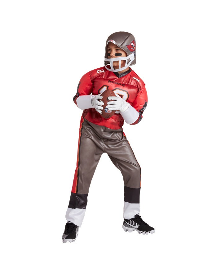 A boy with red and grey rugby attire and rugby ball along with helmet