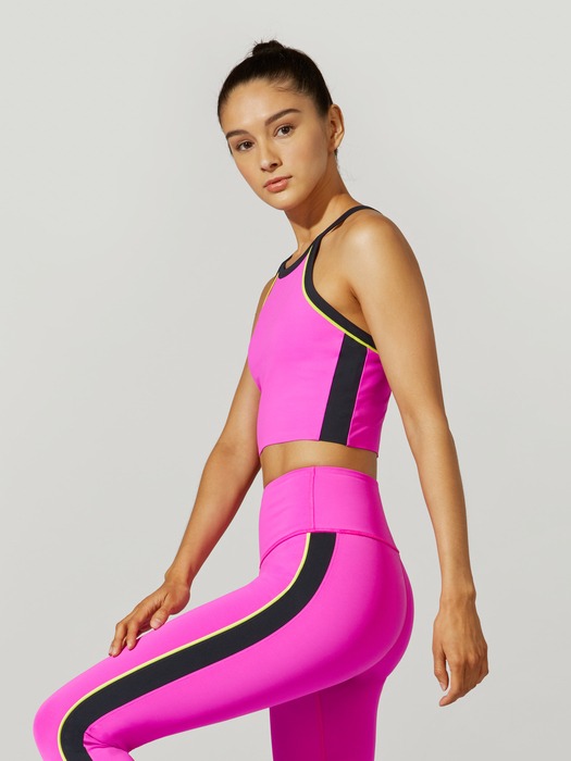 A female model with pink gym attire side view