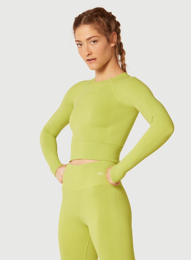 A female model wearing green trousers and green top with full hands front view