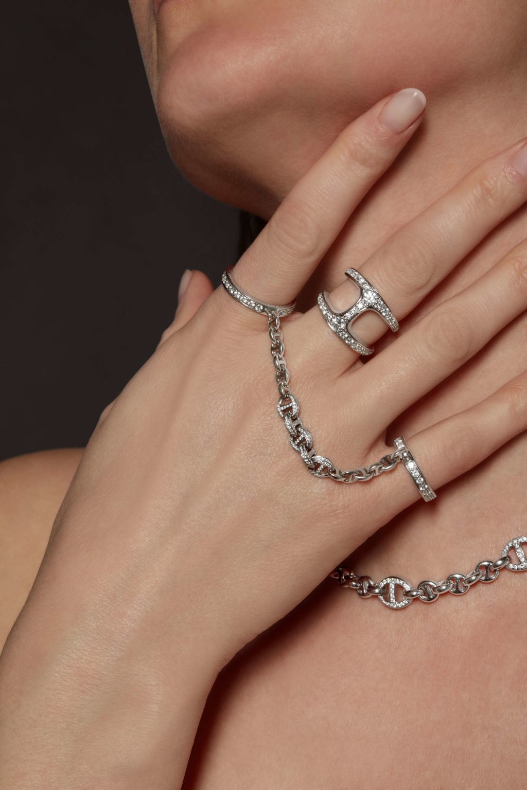 Image of a lady wearing diamond chain and stylish diamond rings with chain