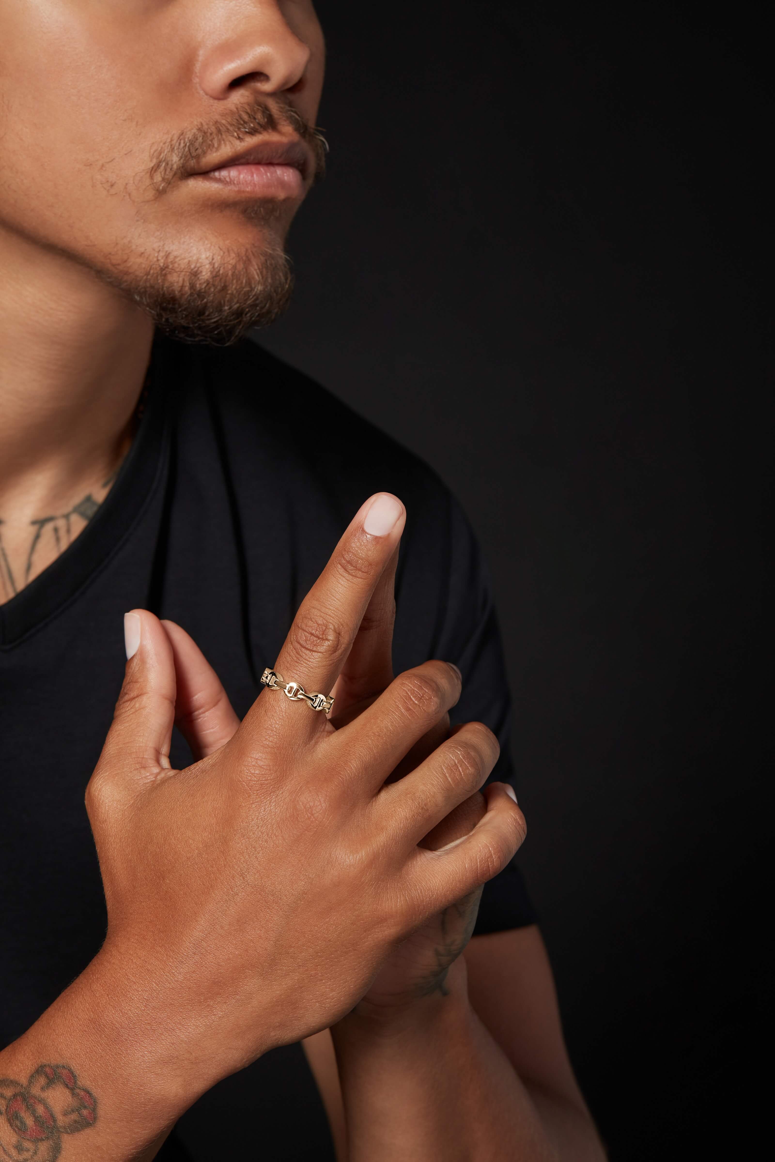 A male model with his both hands joined in a manner of thinking something
