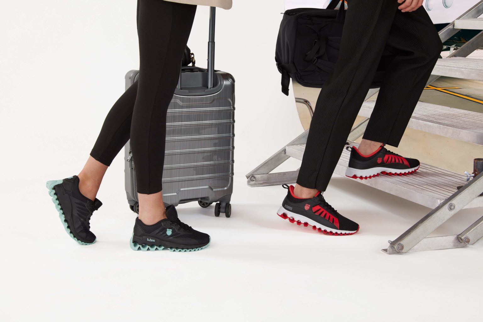 Image showing a male and female walking legs along with a travel suitcase