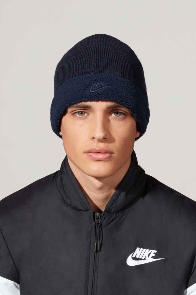 A male model with Nike jerkin and a Nike head cap
