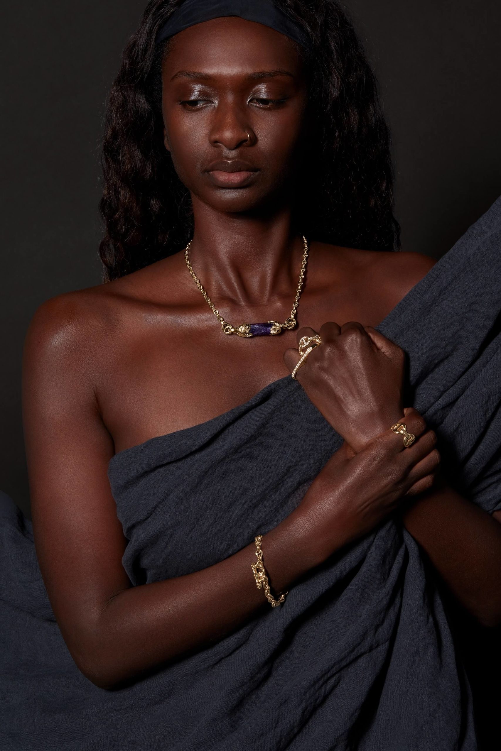 A Tribal look alike female model with bracelet , rings and necklace