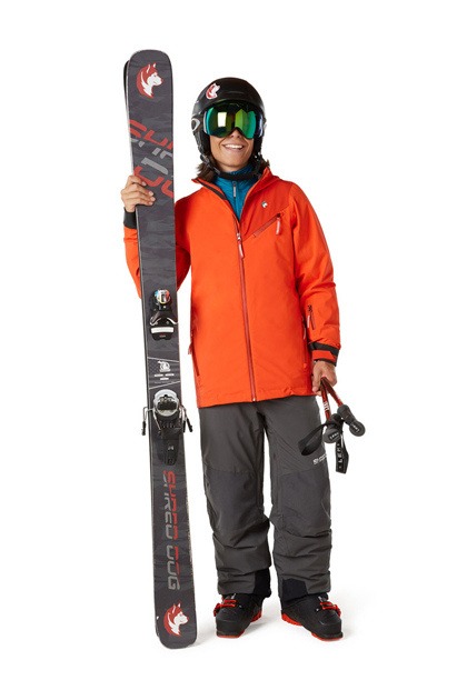 A boy with grey and orang skiing attire along with shoes , glasses and skiing board