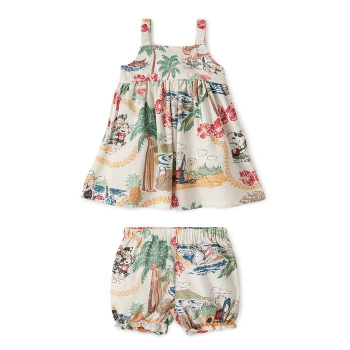A girl dress short and top with with beack ,palm trees and flowers on it