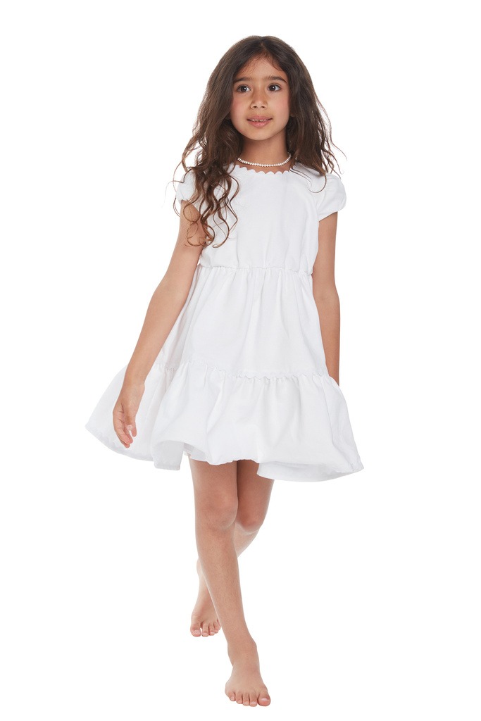 A bubbly small girl with white dress