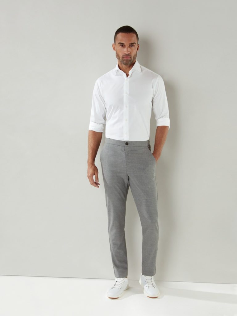 A male model with formal grey pant and white shirt