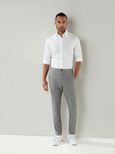 A male model with formal grey pant and white shirt