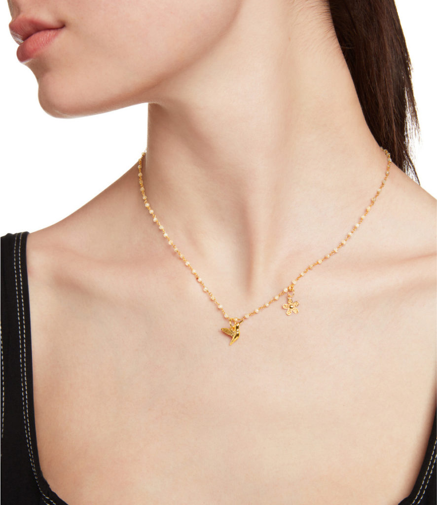 A female model showing her neck with a necklace
