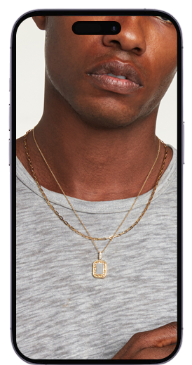 A male model showing his hand having rings , bracelet and necklace in a mobile frame